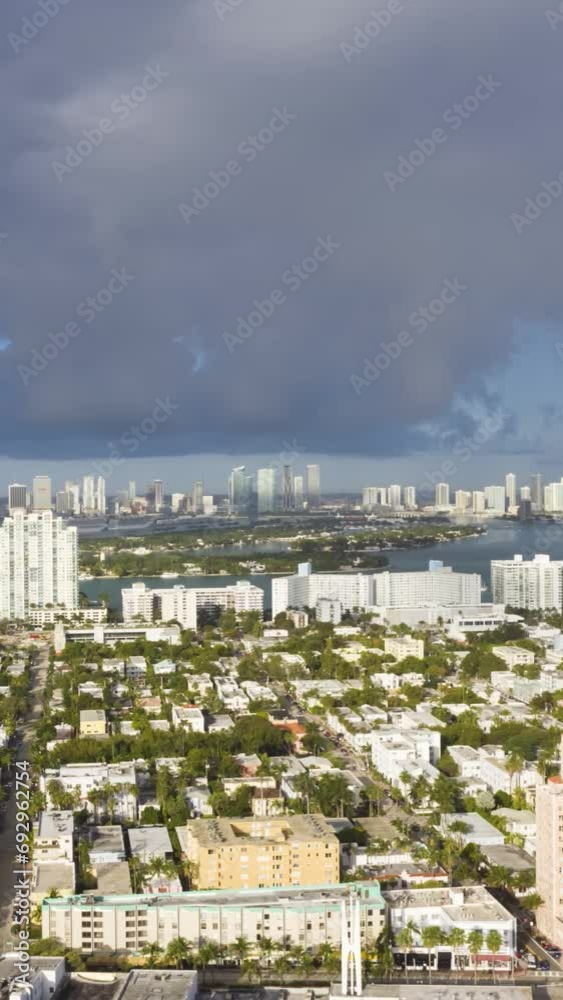 Urban Skyline of Miami Beach and Miami Downtown and Stormy Sky. Dark Clouds. Aerial Hyper Lapse, Time Lapse. USA. Drone Flies Sideways and Upwards. Vertical Video Urban Skyline of Miami Beach and Miami Downtown and Stormy Sky. Dark Clouds. Aerial Hyper Lapse, Time Lapse. USA. Drone Flies Sideways and Upwards. Vertical Video