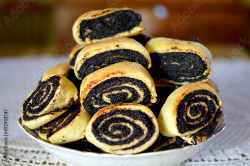 poppy seed and walnut strudels in the vintage ceramic bowl at the table