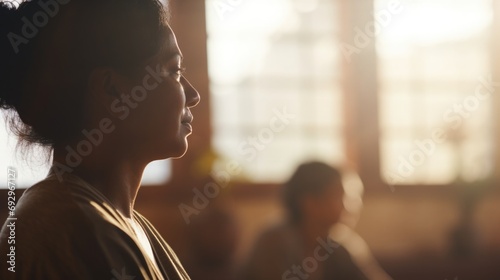 Transgender woman teaching a yoga class, a serene studio setting with soft morning light photo
