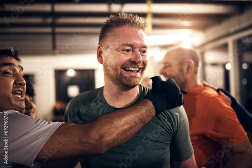 Mature men laughing after a boxing gym workout session photo