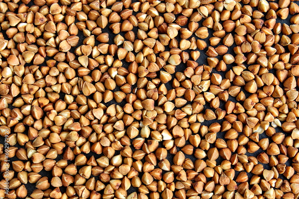 Background of buckwheat lying on a black background. Background of buckwheat lying on a black background.