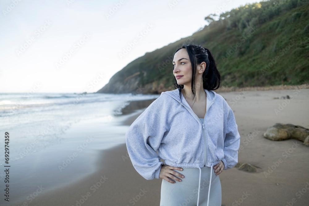 Slim woman contemplating the horizon after doing sports.The concept of active lifestyle, sports training, yoga or fitness. Slim woman contemplating the horizon after doing sports.The concept of active lifestyle, sports training, yoga or fitness.