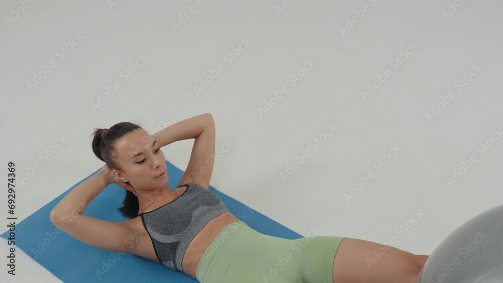 Multiethnic women training in the gym. Concept about a young woman making workout with fitness equipment. Representation of body positivity related to sport concepts. Multiethnic women training in the gym. Concept about a young woman making workout with fitness equipment. Representation of body positivity related to sport concepts.