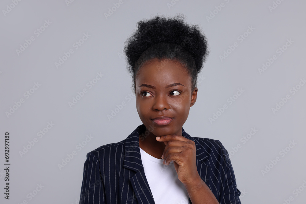 Portrait of beautiful young woman on light grey background Portrait of beautiful young woman on light grey background