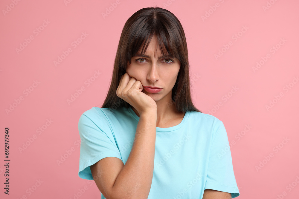 Portrait of resentful woman on pink background Portrait of resentful woman on pink background