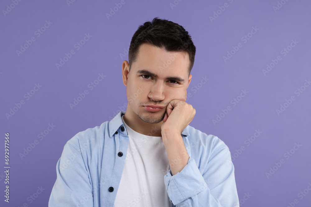 Portrait of resentful man on violet background Portrait of resentful man on violet background