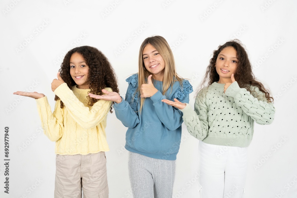 multi racial group of girl friends Showing palm hand and doing ok gesture with thumbs up, smiling happy and cheerful. multi racial group of girl friends Showing palm hand and doing ok gesture with thumbs up, smiling happy and cheerful.