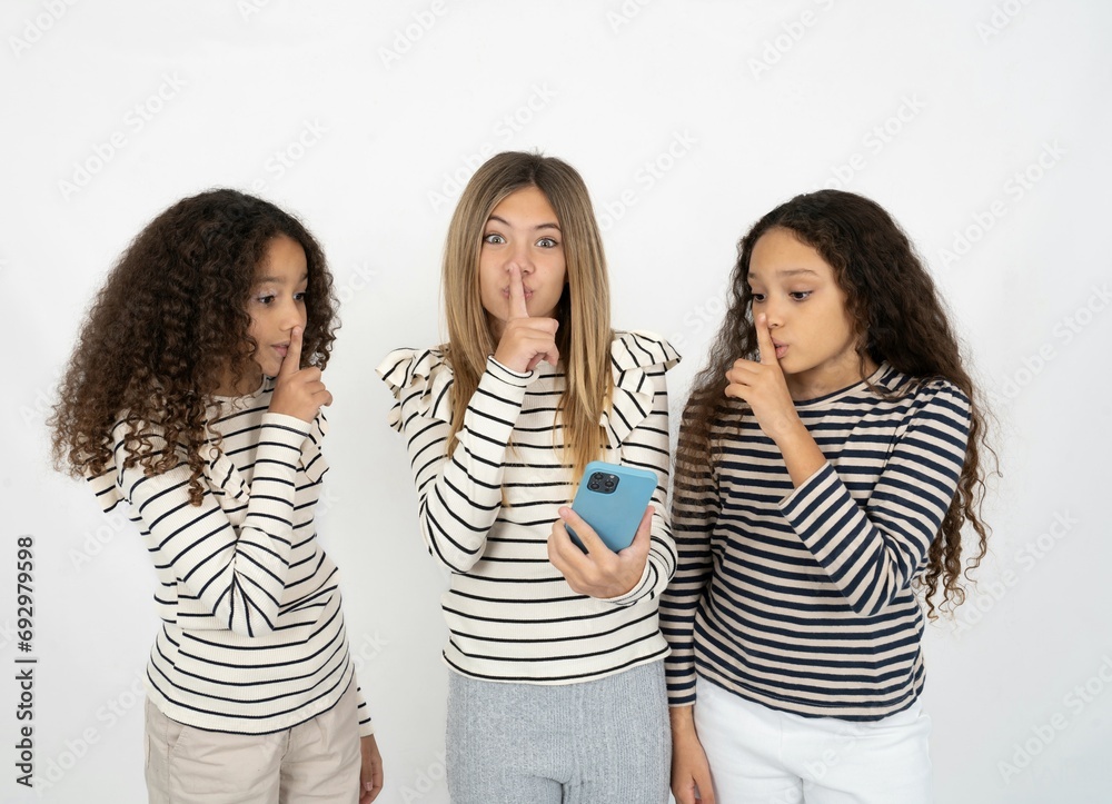 multi racial group of girl friends holding modern gadget ask not tell secrets multi racial group of girl friends holding modern gadget ask not tell secrets
