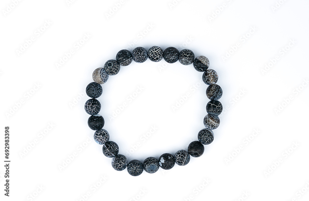 Natural stone bracelet on the white background. Top view. Close-up. Natural stone bracelet on the white background. Top view. Close-up.