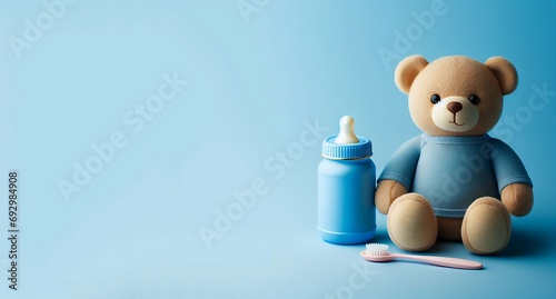 A teddy bear wearing blue shirt with a kids' milk bottle and brush on blue isolated background, Toys for toddlers with copy space for text, AI generated