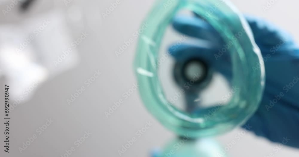 The anesthesia mask is lowered, close-up, top-down view. Anesthesiology in medical operation, hospital The anesthesia mask is lowered, close-up, top-down view. Anesthesiology in medical operation, hospital