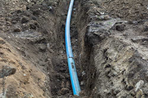 Plumbing pipe laying. Plastic polypropylene pipe. Sanitary, sewer drainage system for a multi-story building. Civil infrastructure pipe, water lines and storm sewers. Selective focus, shallow depth