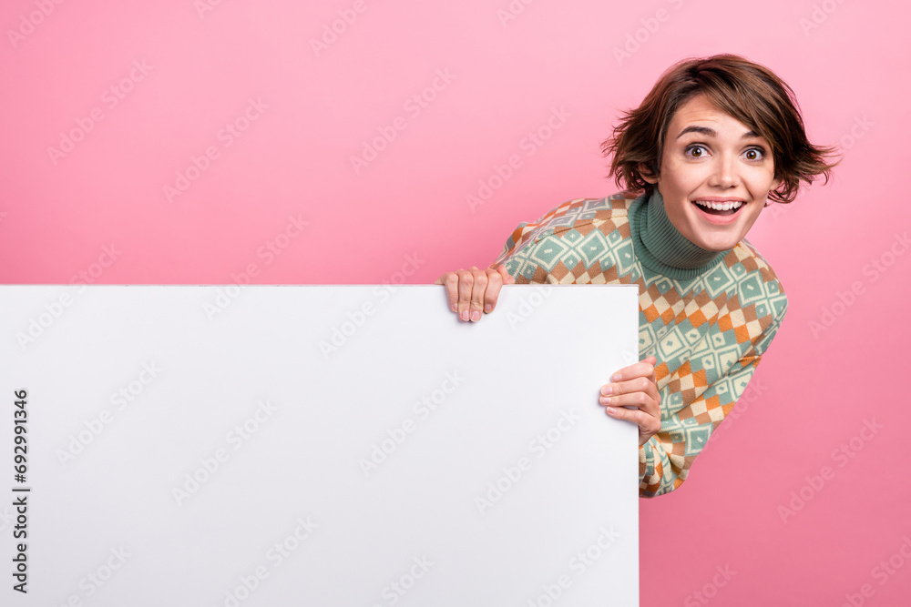 Photo of funny girl hiding holding hands billboard empty space banner surprise advertising promo discount isolated on pink color background Photo of funny girl hiding holding hands billboard empty space banner surprise advertising promo discount isolated on pink color background