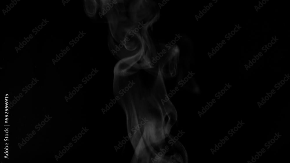 White steam from hot food or drink. White steam on a black background rises to the top. Cooking a hot meal in the kitchen. White steam from hot food or drink. White steam on a black background rises to the top. Cooking a hot meal in the kitchen.