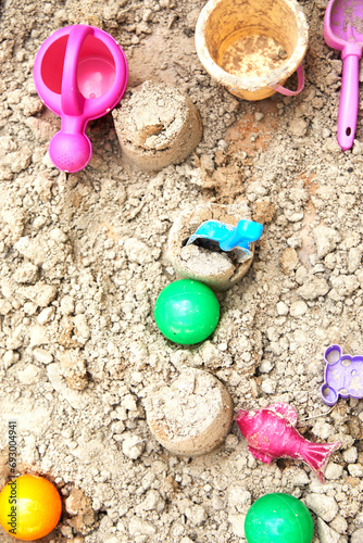 Children's sandbox with various toys for the game in summer day