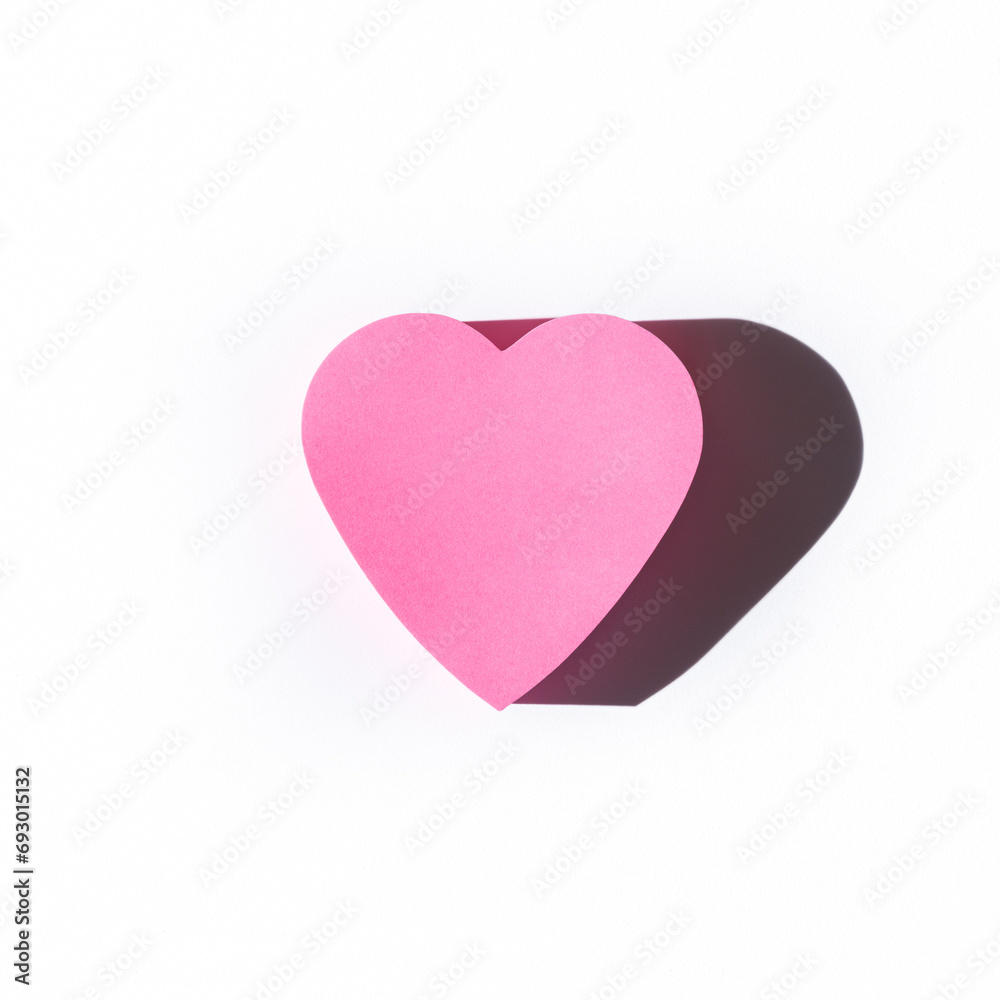 Pink paper heart on white background. Minimal love or like conce