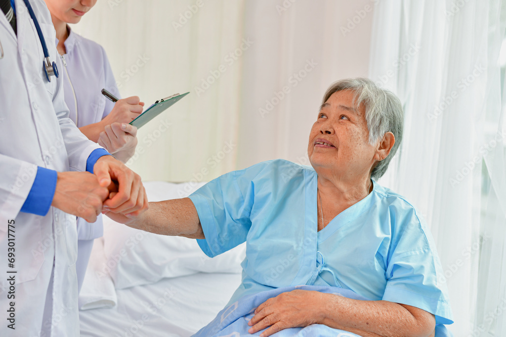 Doctor comforting patient in hospital room. He is holding the hand of a patient in the ward. Doctor comforting patient in hospital room. He is holding the hand of a patient in the ward.