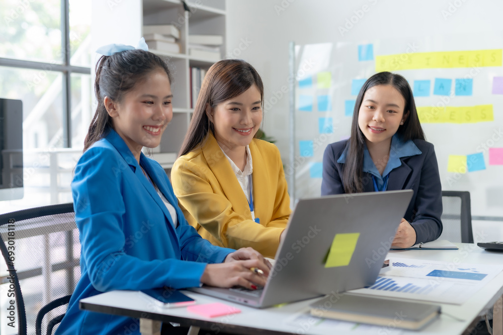 Asian businesswomen collaborate and discuss business plan during team meeting in modern office. Asian businesswomen collaborate and discuss business plan during team meeting in modern office.
