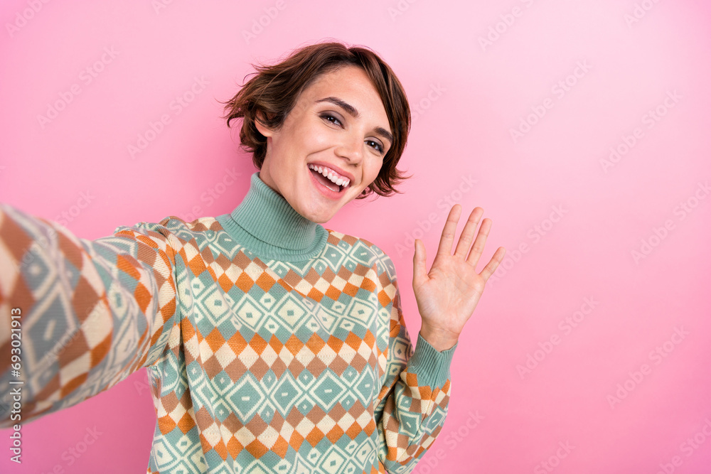 Portrait of selfie cheerful young age girl waving palm greetings recording new video skype conference isolated on pink color background Portrait of selfie cheerful young age girl waving palm greetings recording new video skype conference isolated on pink color background