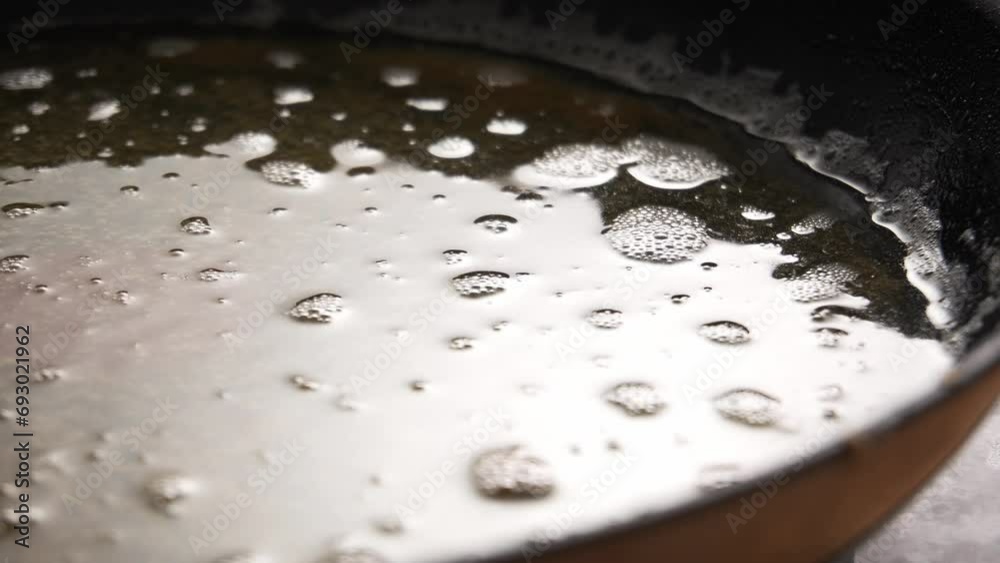 Used Cooking Oil in Frying Pan with bubbles. Close-up, shallow dof. Used Cooking Oil in Frying Pan with bubbles. Close-up, shallow dof.