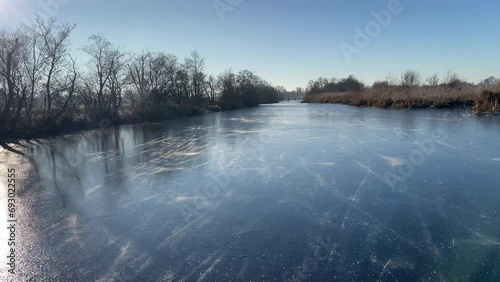 Point of View ice skating in the Weerribben Wieden nature reserve in The Netherlands during a beautiful winter day photo