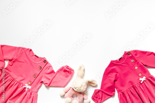 Baby fashion concept - pink dress with toy. Kids set background