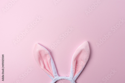 Pink bunny ears on pink background. Minimal Easter concept.