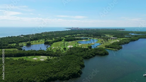 Aerial view on beautiful nature of Key Biscayne island with lush green waterfront. Crandon Golf Course and lakes in paradise tropical place under bright sunny sky photo