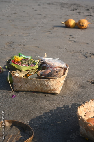 Ritual offerings dispersed on the Cangu beaches in Bali, Indonesia photo