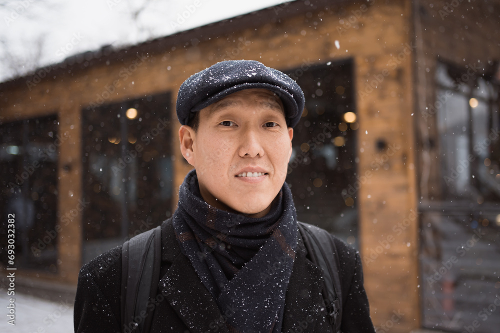 Face of Asian young adult man outdoors in winter Face of Asian young adult man outdoors in winter