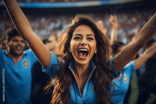 Enthusiastic woman in blue shirt, fan cheering for victory in a sports competition. Diverse team spirit. Generative ai image photo