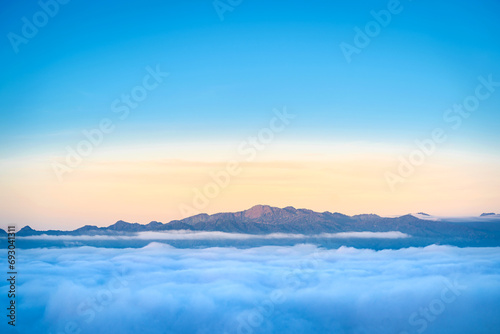 Fototapeta Naklejka Na Ścianę i Meble -  Beautiful natural scenery with a sea of mist around mountain peaks in the morning on the hills amidst Thailand's lush green forests ecologically fertile.