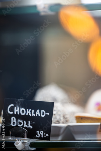 Stockholm, Sweden A displayof cakes and sweets in a pastry shop or cafe with signs in Swedish. Chocolate balls. photo