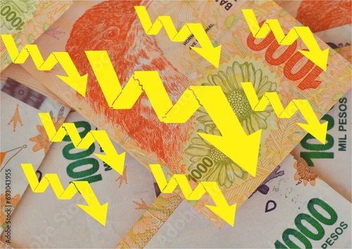 background of Argentine peso bills with denomination of 1000 pesos and yellow arrows going down, concept of devaluation of the Argentine peso