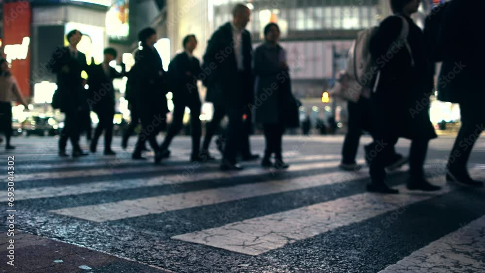 Crowd of busy unrecognisable people walking on a pedestrian crossing in Tokyo, Shibuya, Japan, pedestrian crossing at night, overcrowded urban lifestyle concept Crowd of busy unrecognisable people walking on a pedestrian crossing in Tokyo, Shibuya, Japan, pedestrian crossing at night, overcrowded urban lifestyle concept