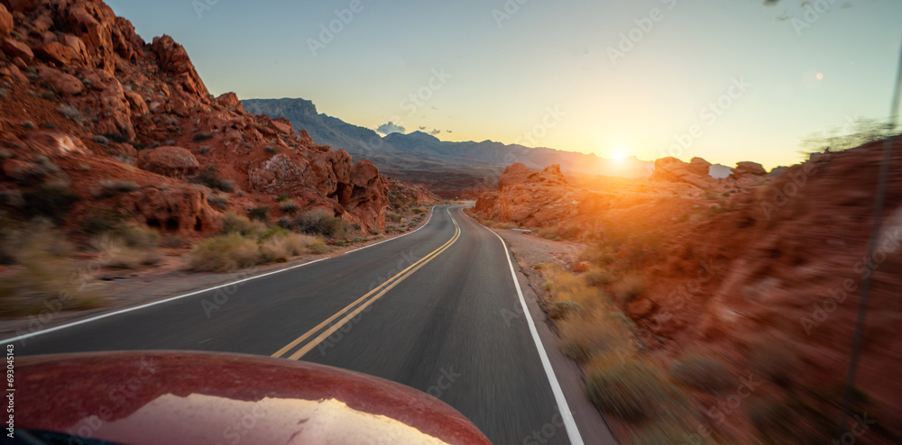 Empty long nevada mountain road to the horizon on a sunny summer day at bright sunset