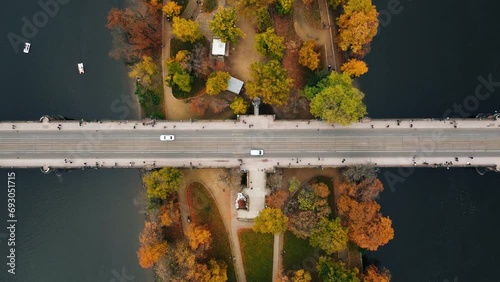 Top view (aerial view) of bridge (road) with cars over the colorful Strelecky Island with beautiful yellow trees in Prague Czechia - autumn season. photo
