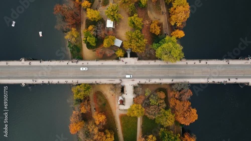 Top view (aerial view) of bridge (road) with cars over the colorful Strelecky Island with beautiful yellow trees in Prague Czechia - autumn season.