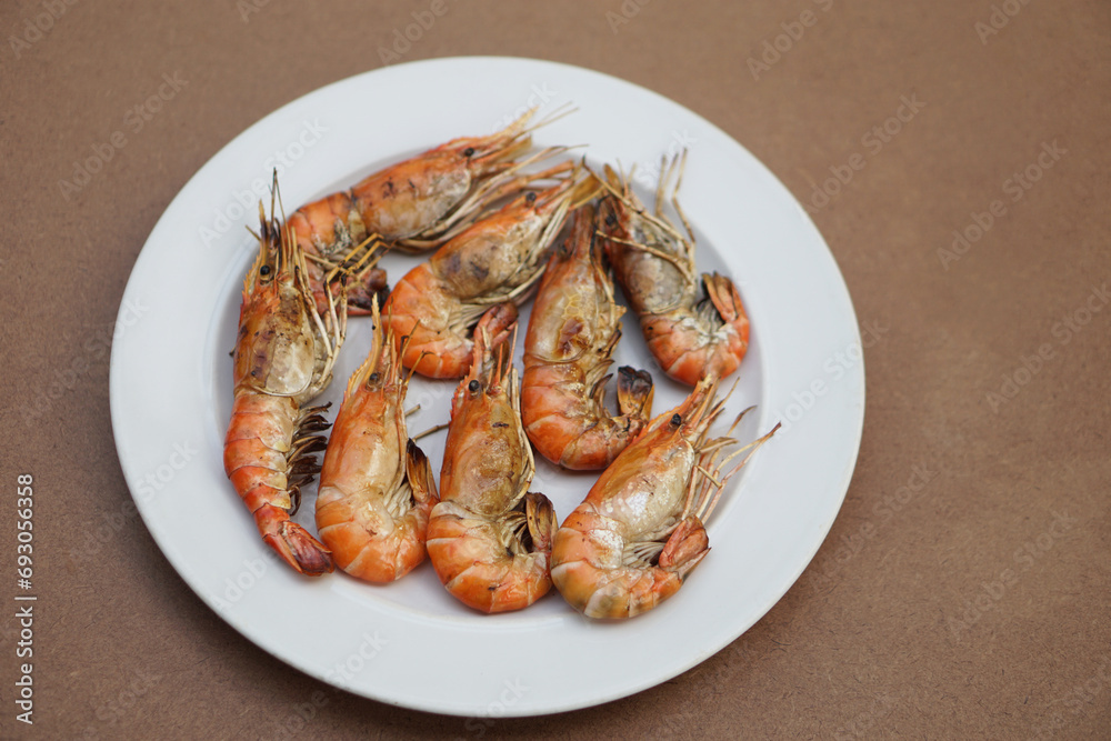Grilled prawns, river shrimps on white plate. Concept, seafood. Delicious, favorite menu for party or outdoor barbeque or picnic. Healthy food. Ready to eat. Thai eating style. Grilled prawns, river shrimps on white plate. Concept, seafood. Delicious, favorite menu for party or outdoor barbeque or picnic. Healthy food. Ready to eat. Thai eating style.