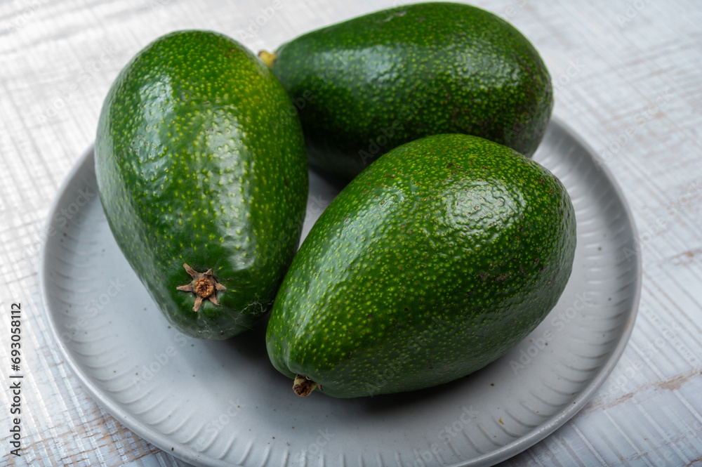 Green ripe avocado fruits from organic avocado plantation - healthy food Green ripe avocado fruits from organic avocado plantation - healthy food