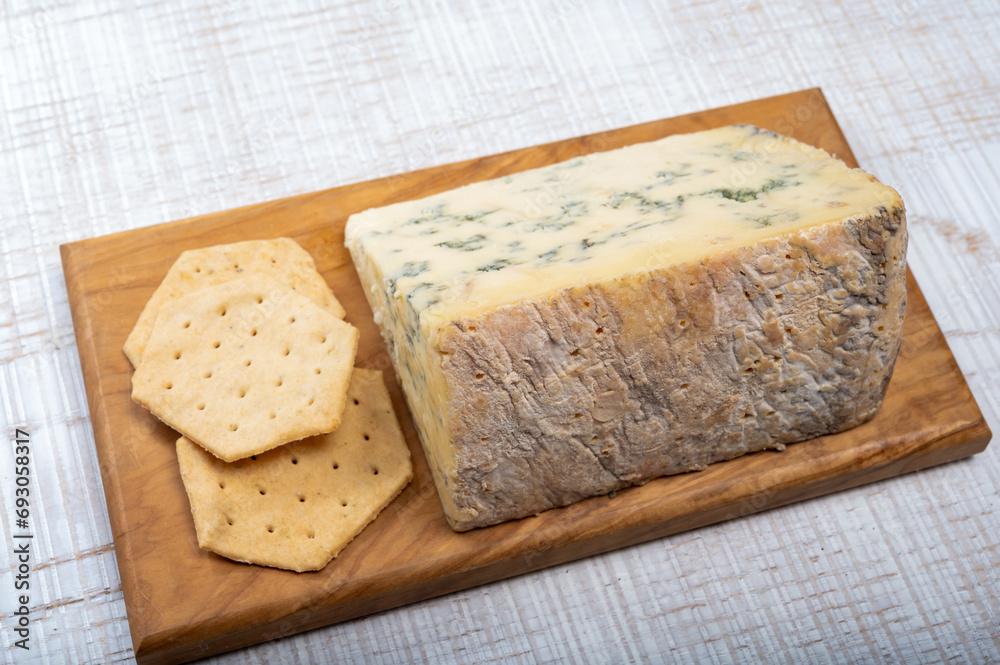 Cheese collection, English semi-soft, crumbly old stilton blue cheese close up Cheese collection, English semi-soft, crumbly old stilton blue cheese close up