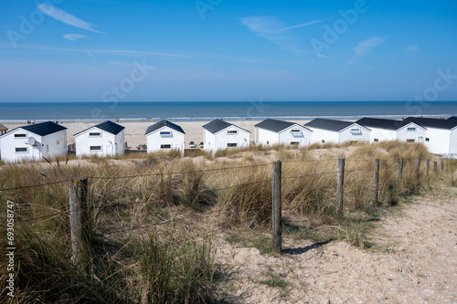 Beach holidays on sandy beach  waterfront wooden cottages in Katwijk-on-zee  North sea  Netherlands