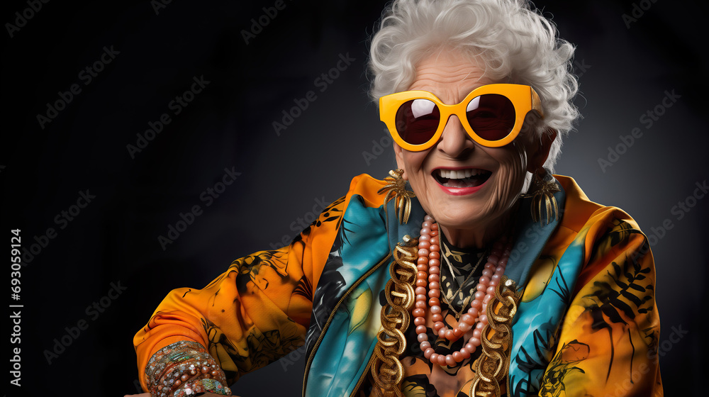 Crazy old granny with gold chain, watch and sunglasses, funny old woman with gray hair, expressive mature and happy smiling grandmother in colorful close-up portrait Crazy old granny with gold chain, watch and sunglasses, funny old woman with gray hair, expressive mature and happy smiling grandmother in colorful close-up portrait