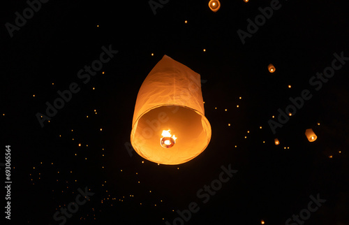 Thai people release sky floating lanterns or lamp to worship Buddha's relics at night. Traditional festival in Chiang mai, Thailand. Loy krathong