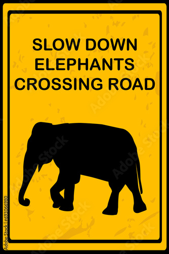 Slow Down Elephants Crossing Road sign