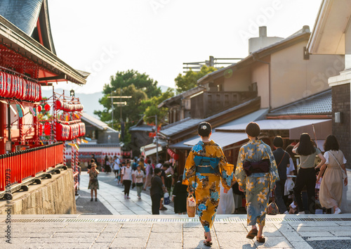 Back view two asian young women wearing Japanese traditional kimono at Fushimi Inari Shrine during the Motomiya Matsuri Festival. Kyoto, Japan.