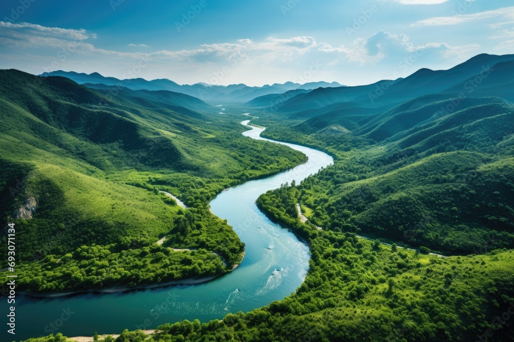 Stunning aerial view of a winding river through lush green forests, pristine natural beauty