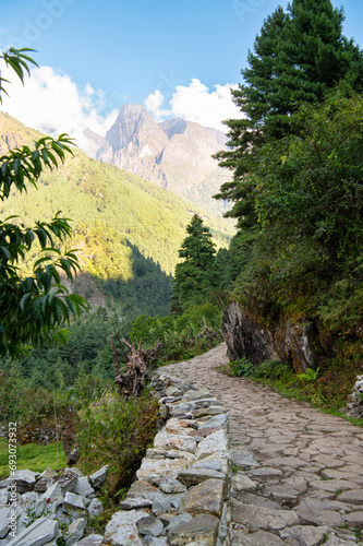 Landscape with road, mountains, clouds and forest during EBC Everest bace camp or Three passes trekking in Sagarmatha national park, Nepal. photo