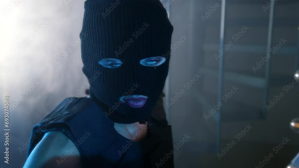 alluring woman with balaclava on head looking at her reflection in mirror and dancing, portrait alluring woman with balaclava on head looking at her reflection in mirror and dancing, portrait