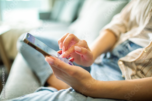 Woman using smartphone to conduct online mobile banking